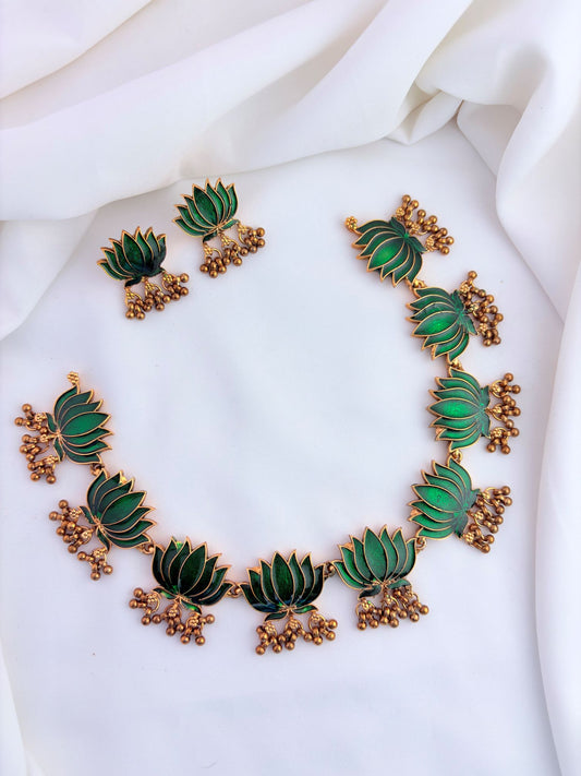 Elegant lotus design necklace set featuring intricate enamel work and matching earrings.