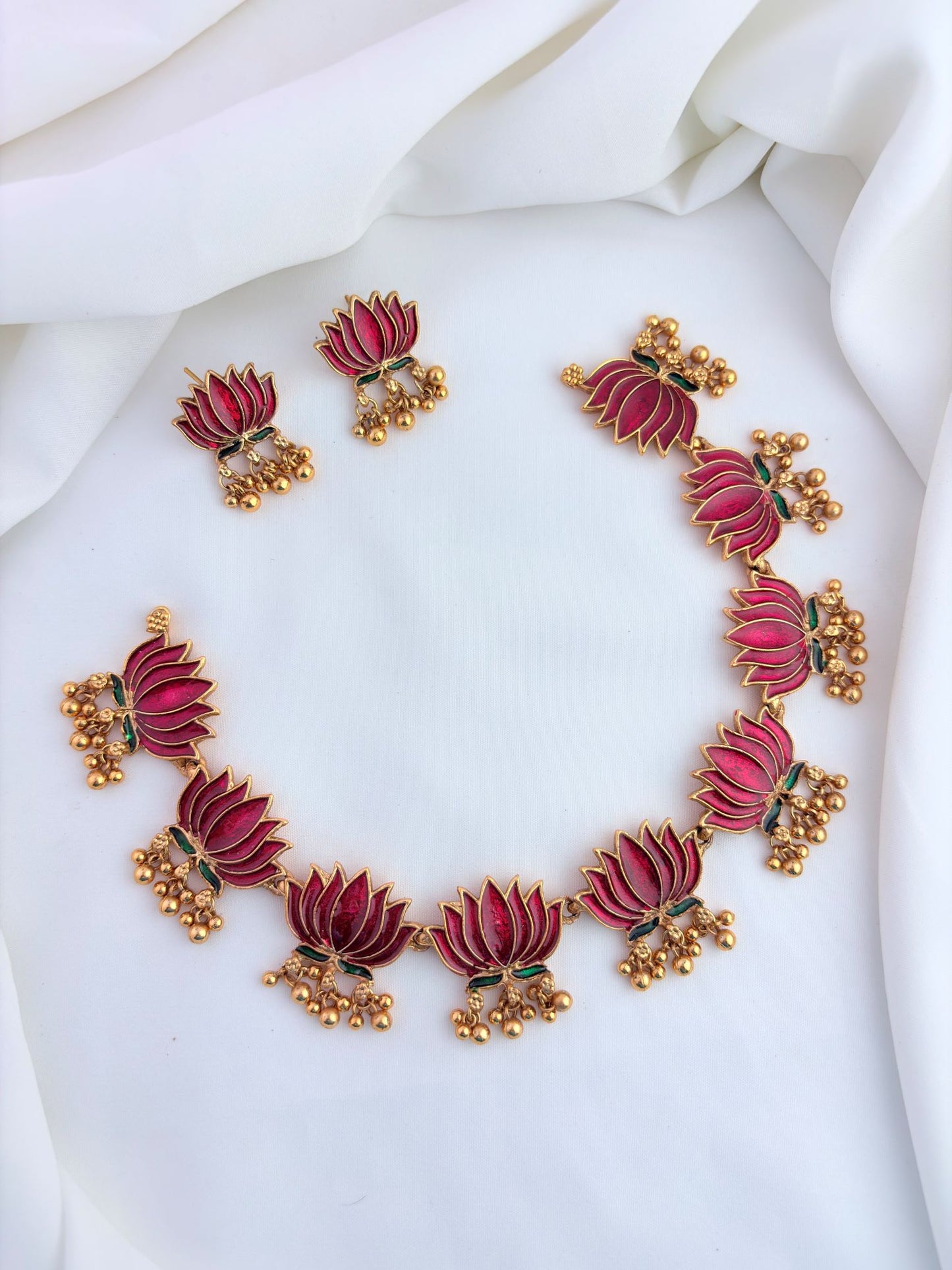 Elegant lotus design necklace set featuring intricate enamel work and matching earrings.