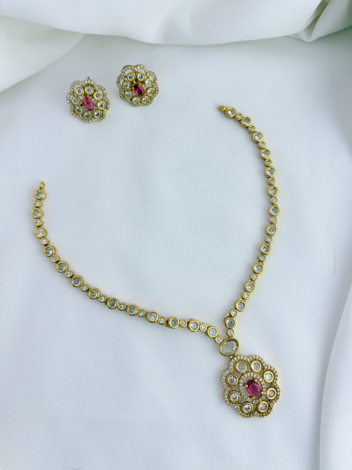 Classic matte finish floral pendant necklace and earrings adorned with CZ stones