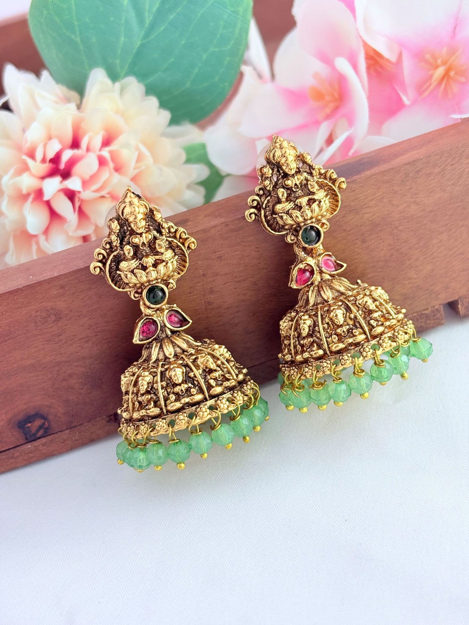 Temple-inspired Lakshmi jhumka in a premium finish beautifully adorned with green beads
