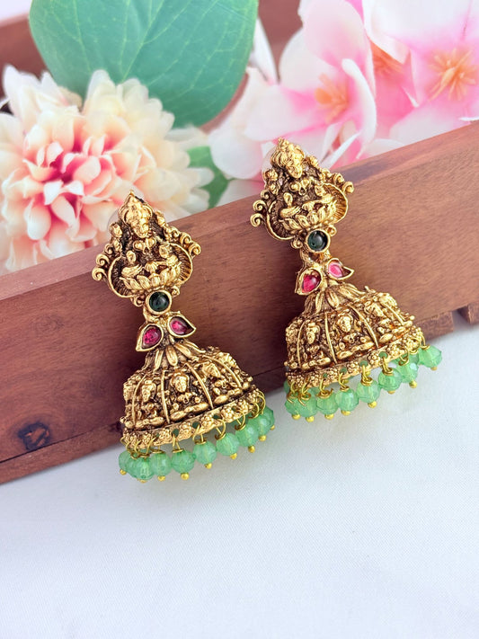 Temple-inspired Lakshmi jhumka in a premium finish beautifully adorned with green beads