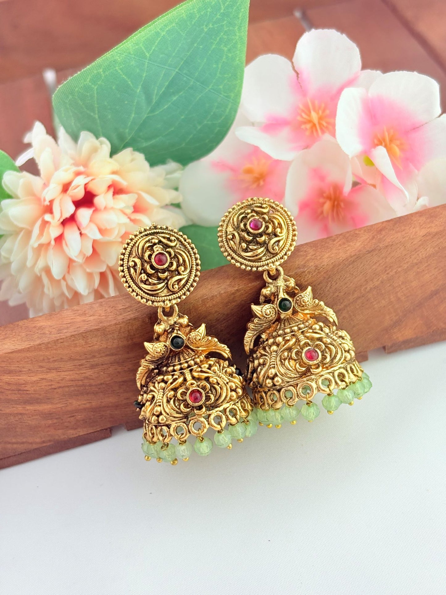 Green bead jhumka inspired by timeless heritage.