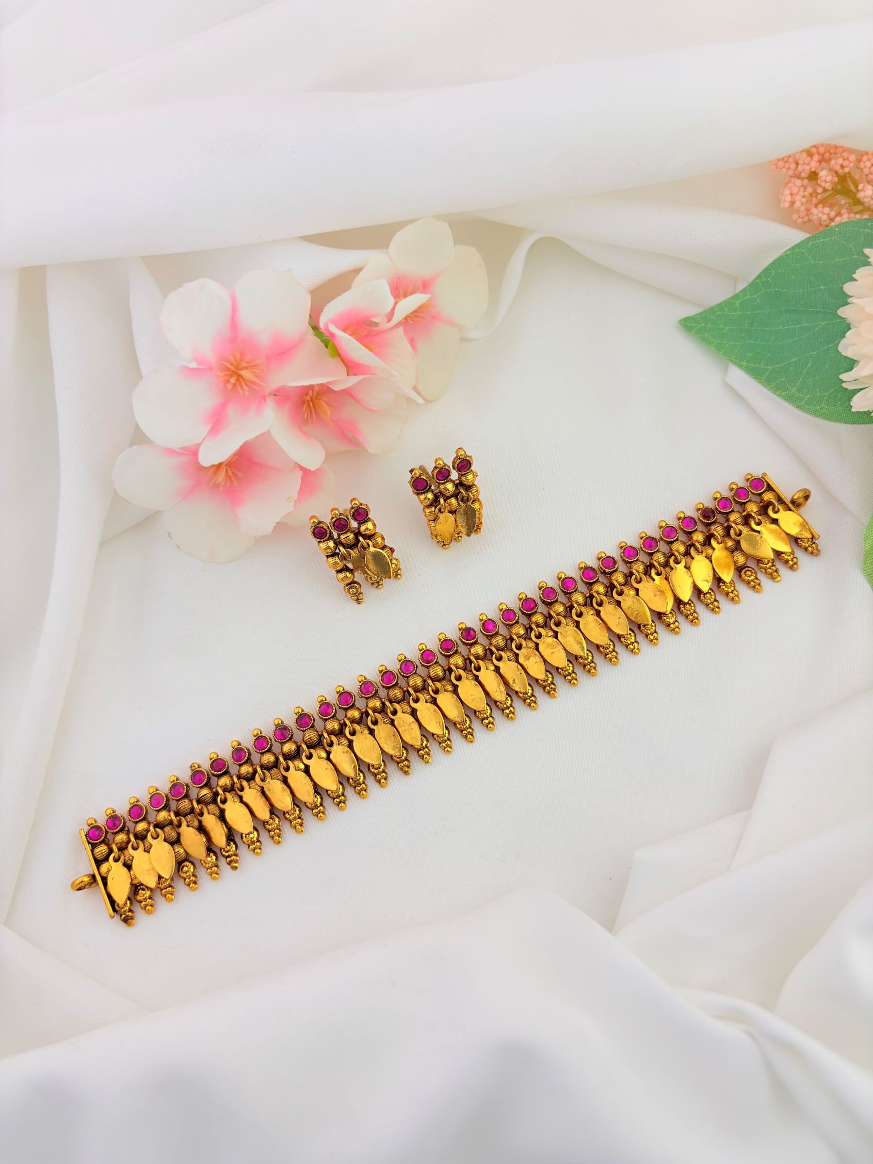 Traditional South Indian Elakkathali jewellery beautifully adorned with ruby and green stones
