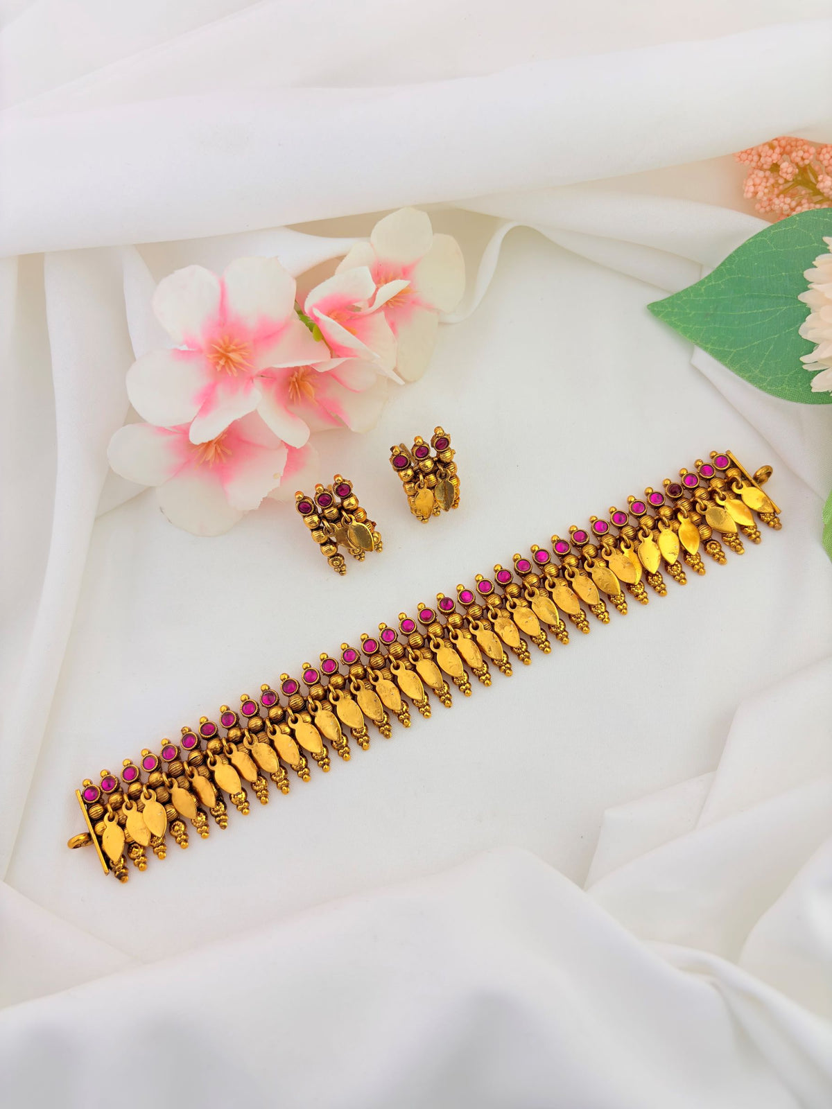 Traditional South Indian Elakkathali jewellery beautifully adorned with ruby and green stones