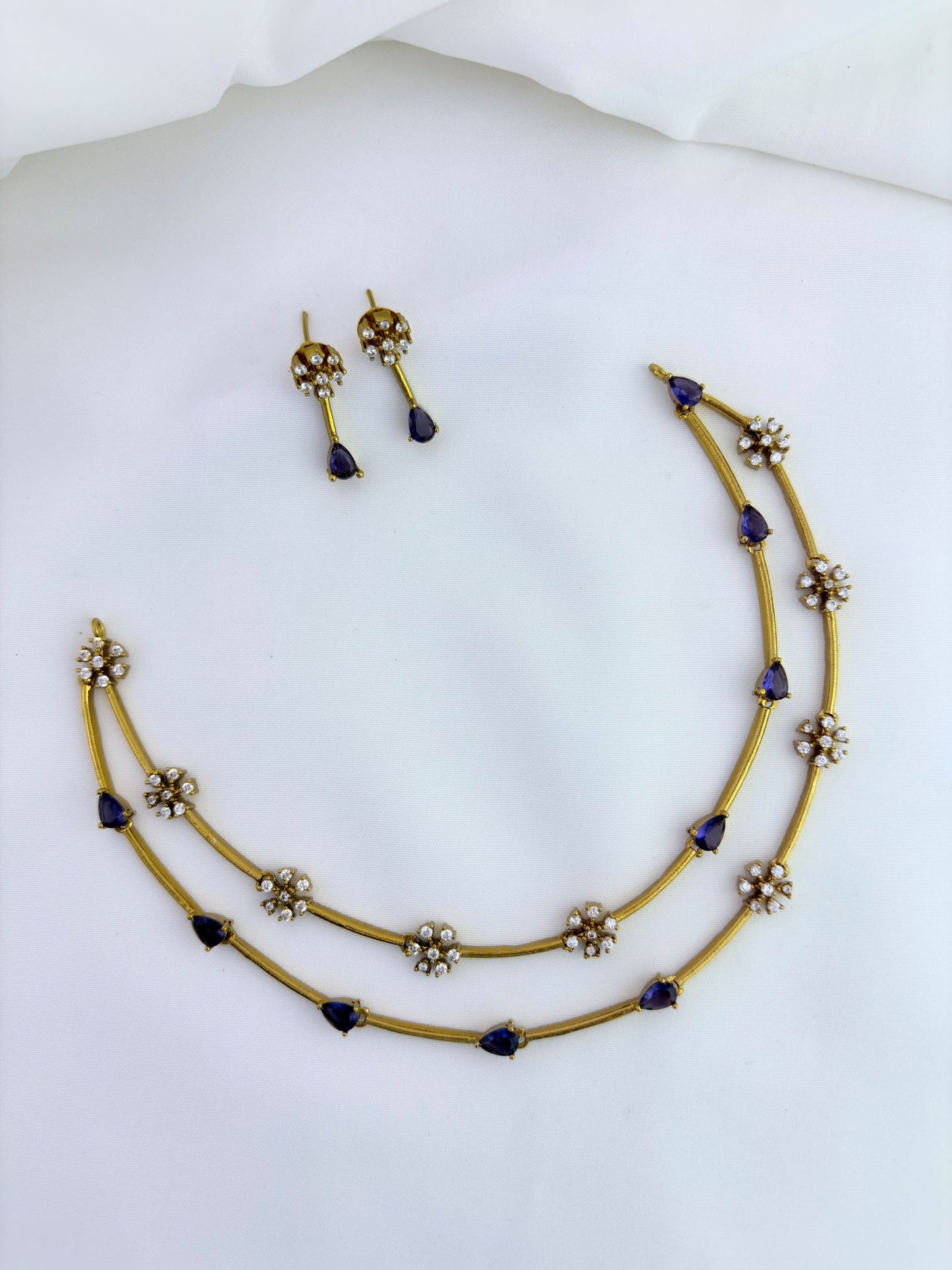 Premium matte finish jewellery designed with elegant craftsmanship adorned with AD stones - Purple