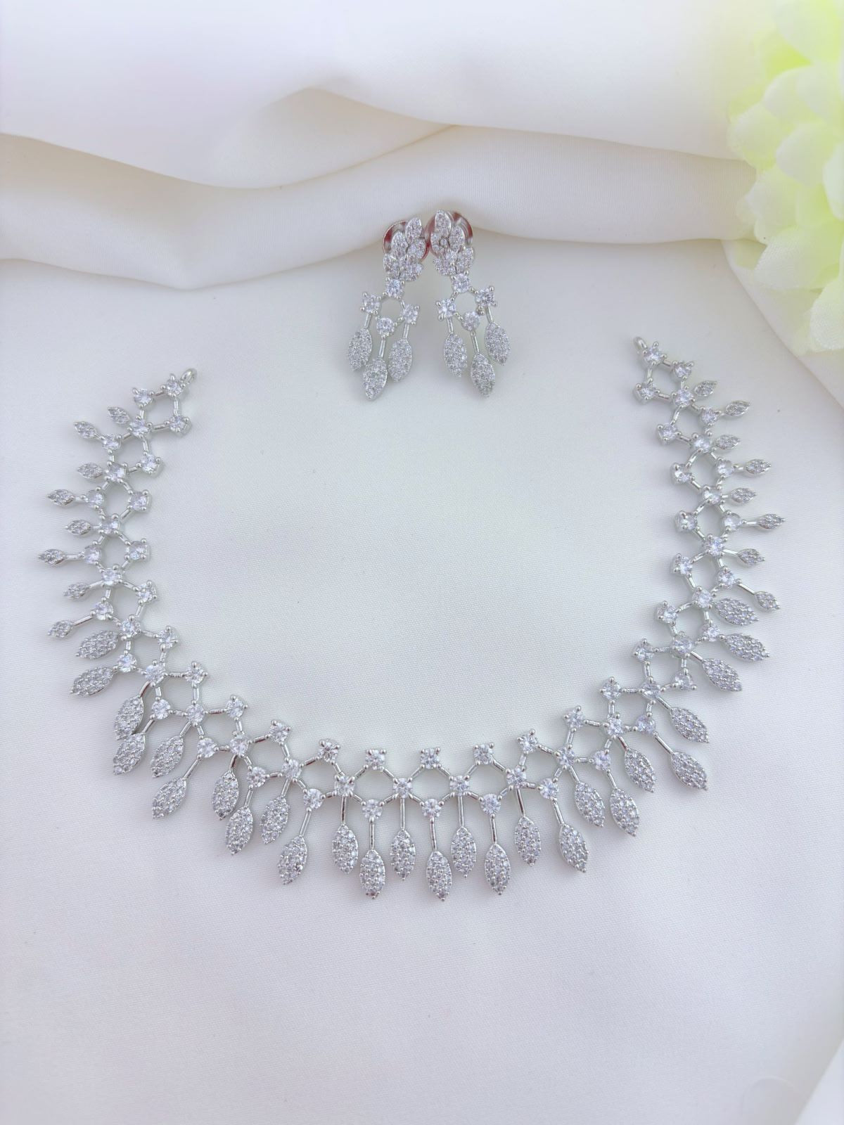 Trending pattern in premium silver polish AD neckset with matching earrings