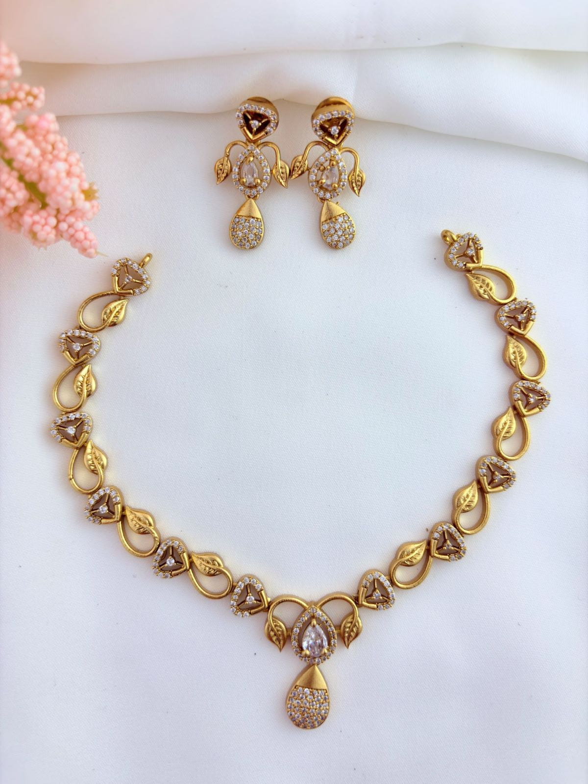 Trending pattern AD stone neckset in premium matte finish paired with matching earrings