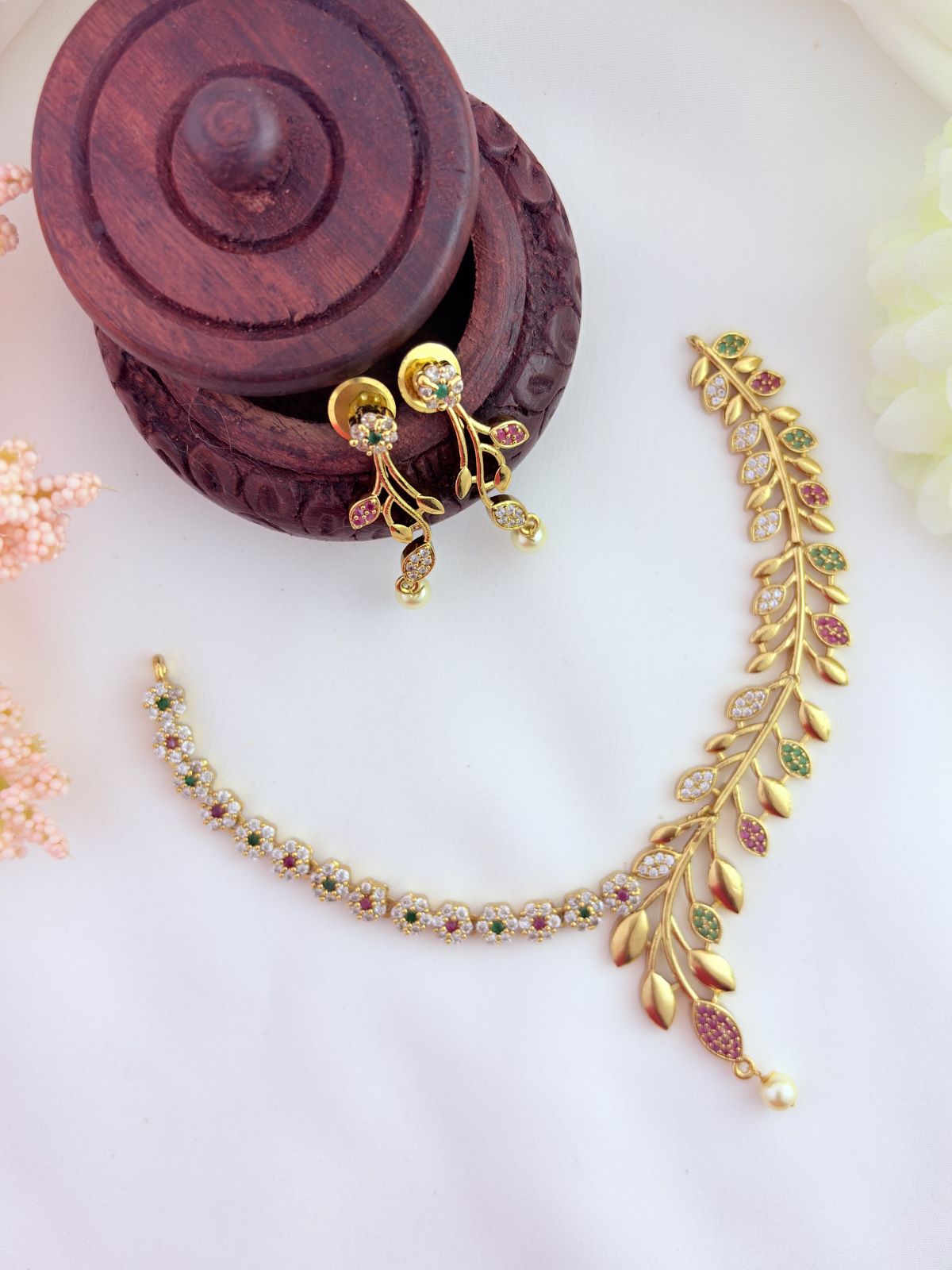 Classic floral and leaf pattern beautifully crafted with AD stones and pearl drops