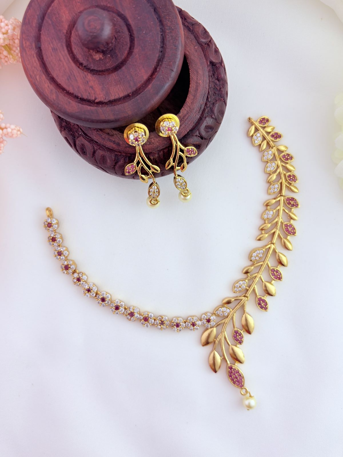 Classic floral and leaf pattern beautifully crafted with AD stones and pearl drops