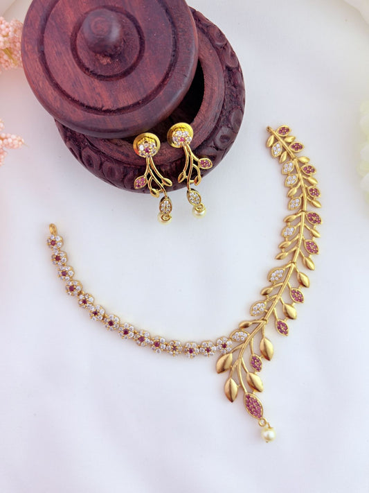 Classic floral and leaf pattern beautifully crafted with AD stones and pearl drops