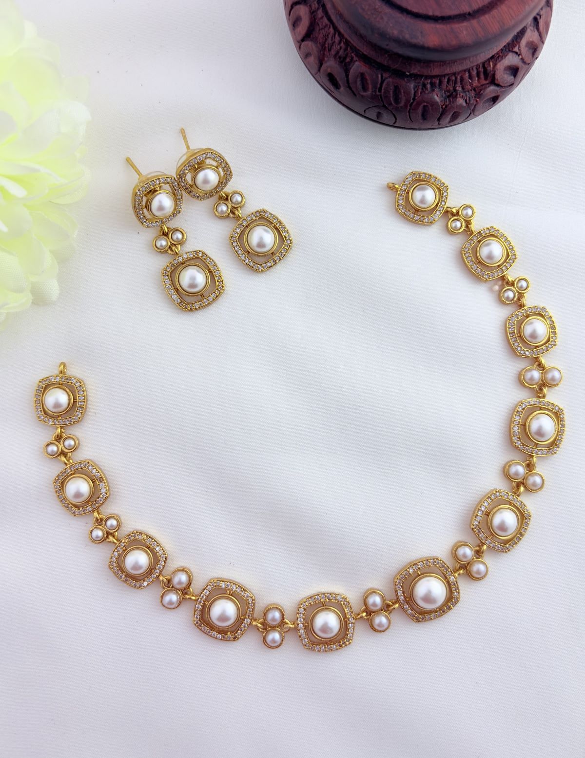A Timeless neckset featuring a stylish design and premium finish adorned with pearls and AD stones