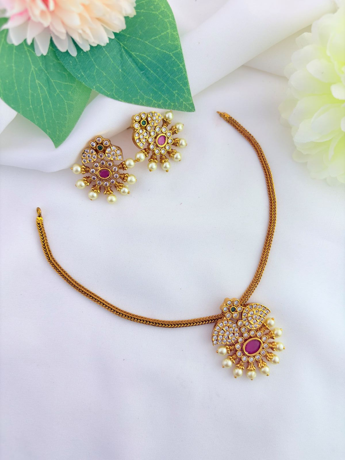 Premium matte finsih neckset and earrings adorned with AD stones and pearls