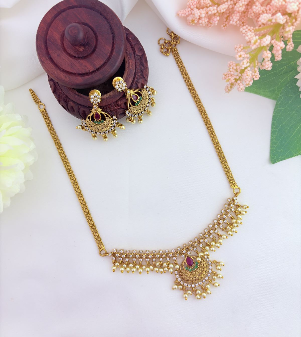 Beautifully crafted with AD stones and pearl drops - Premium matte finish neckset