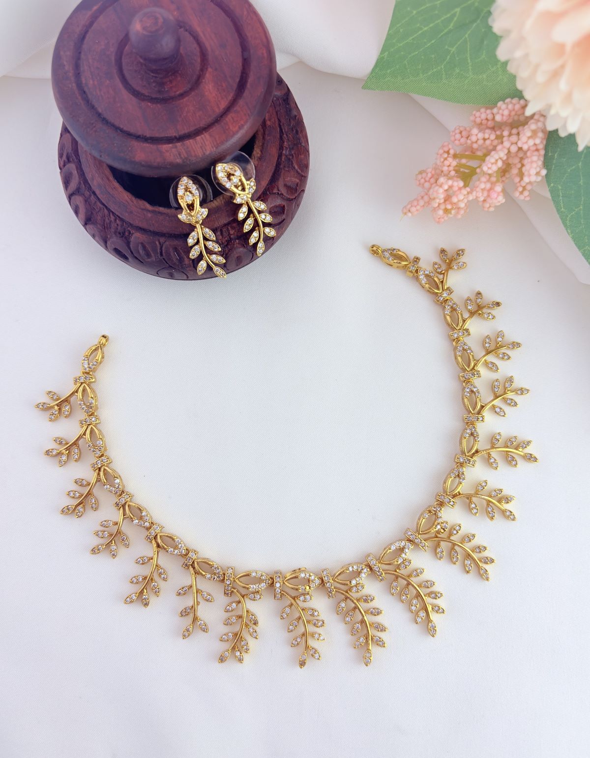 Premium matte finish leaf pattern neckset and earrings beautifully crafted with AD stones