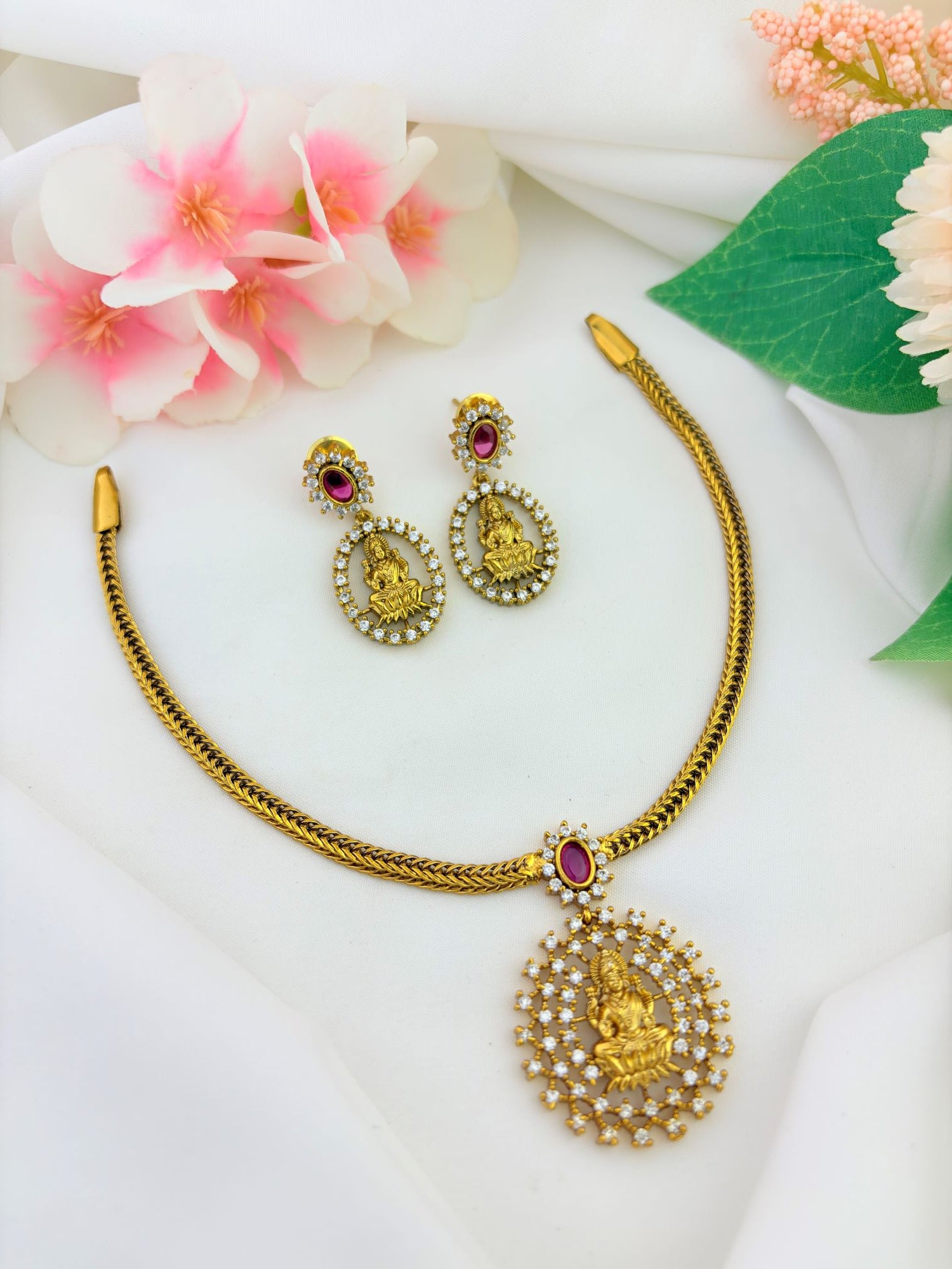 Premium matte finish neckset adorned with ruby and white stones for a rich traditional look