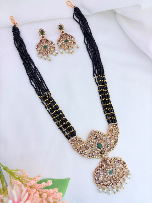 Stylish beads haram featuring a statement pendant and matching earrings adorned with pearl drops