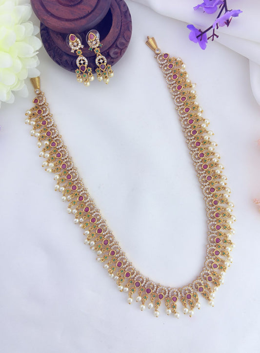Beautifully crafted haram featuring dazzling AD stones,vibrant ruby adn green stones with beads embellishments