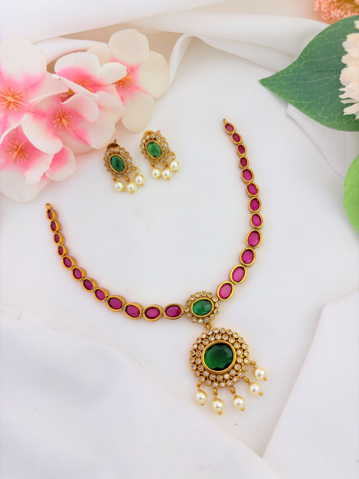 Elegant traditional neckset adorned with ruby, green stone and pearl drops