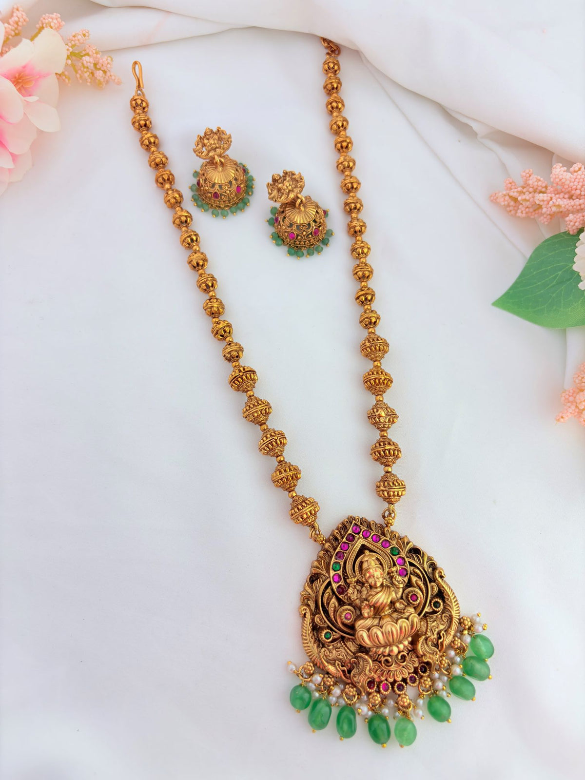 Traditional temple jewellery Haram adorned with ruby and green stones for a divine ethnic look