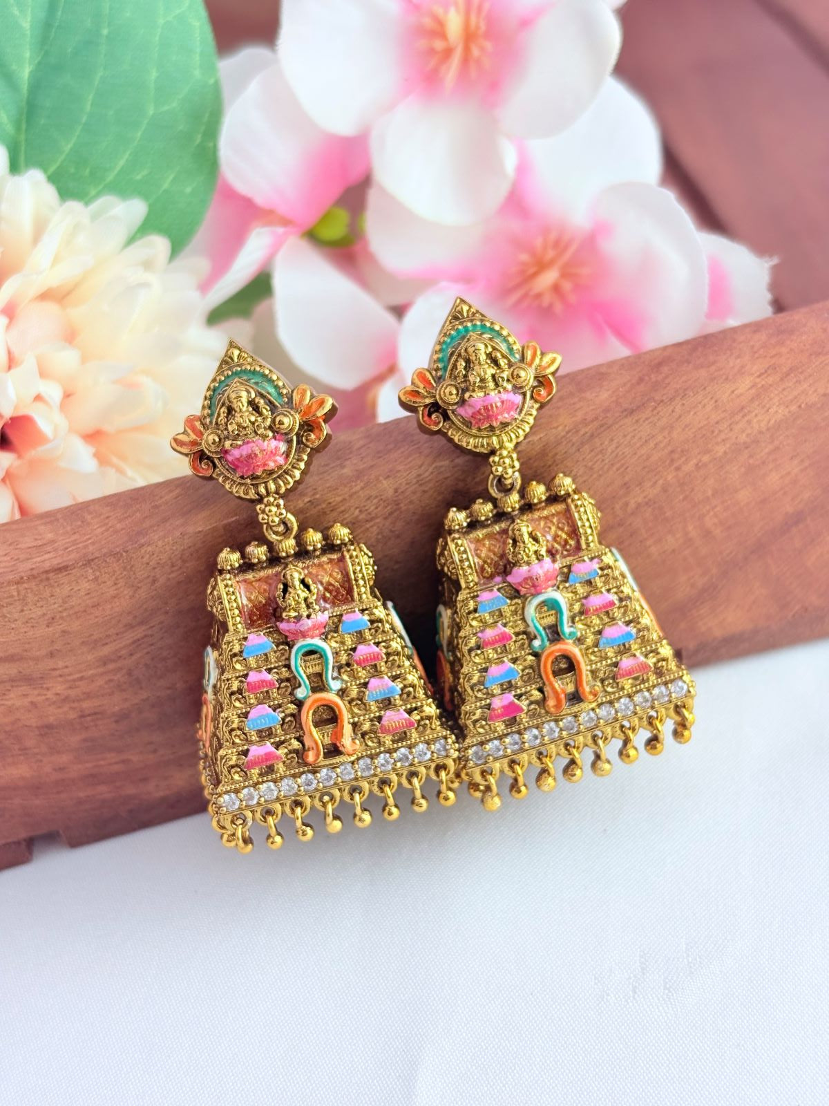 Beautifully crafted gopuram jhumka in premium matte finish adorned wtih golden beads and enamel work