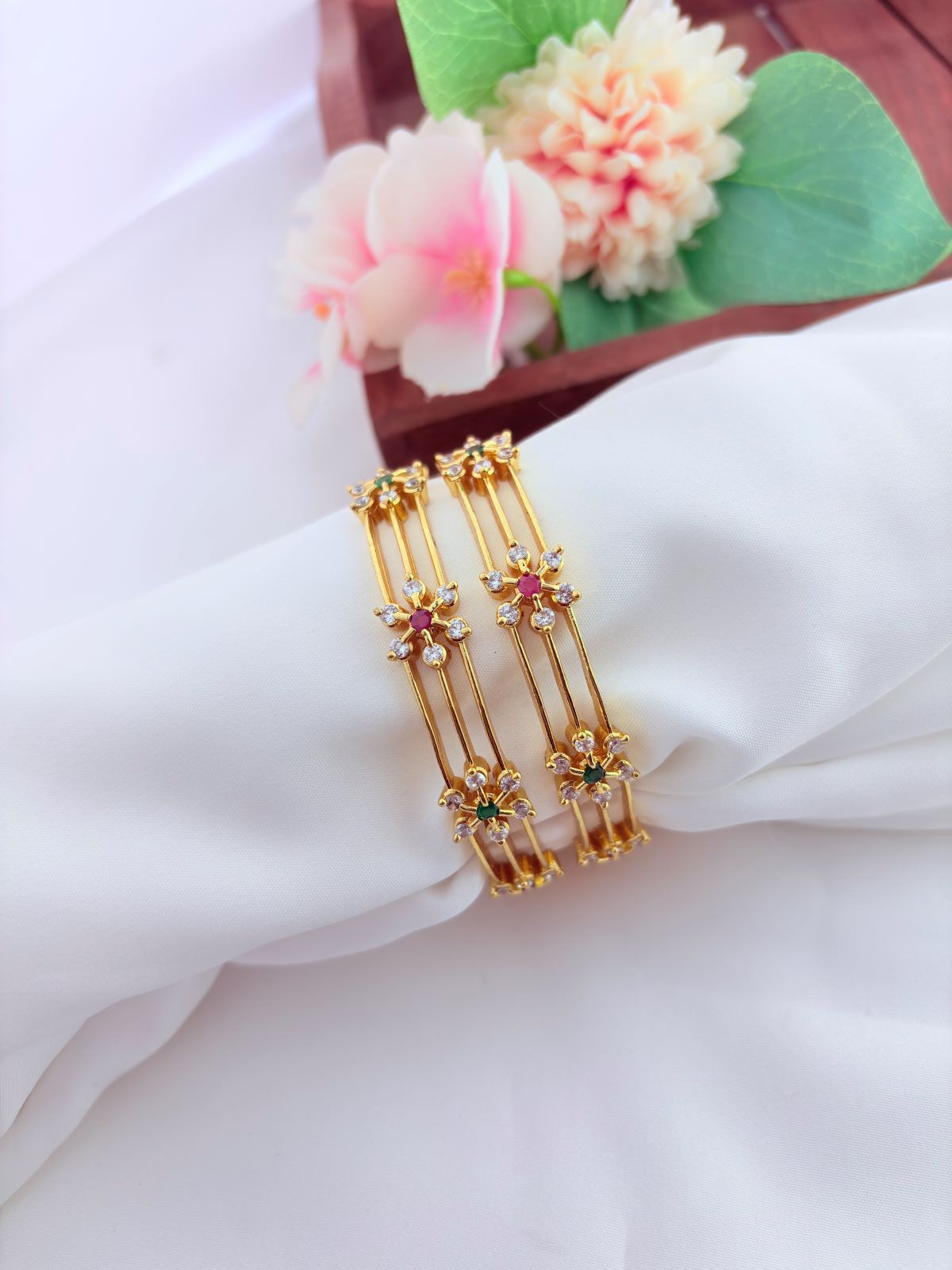 Elegant floral pattern bangles embellished with sparkling AD stones
