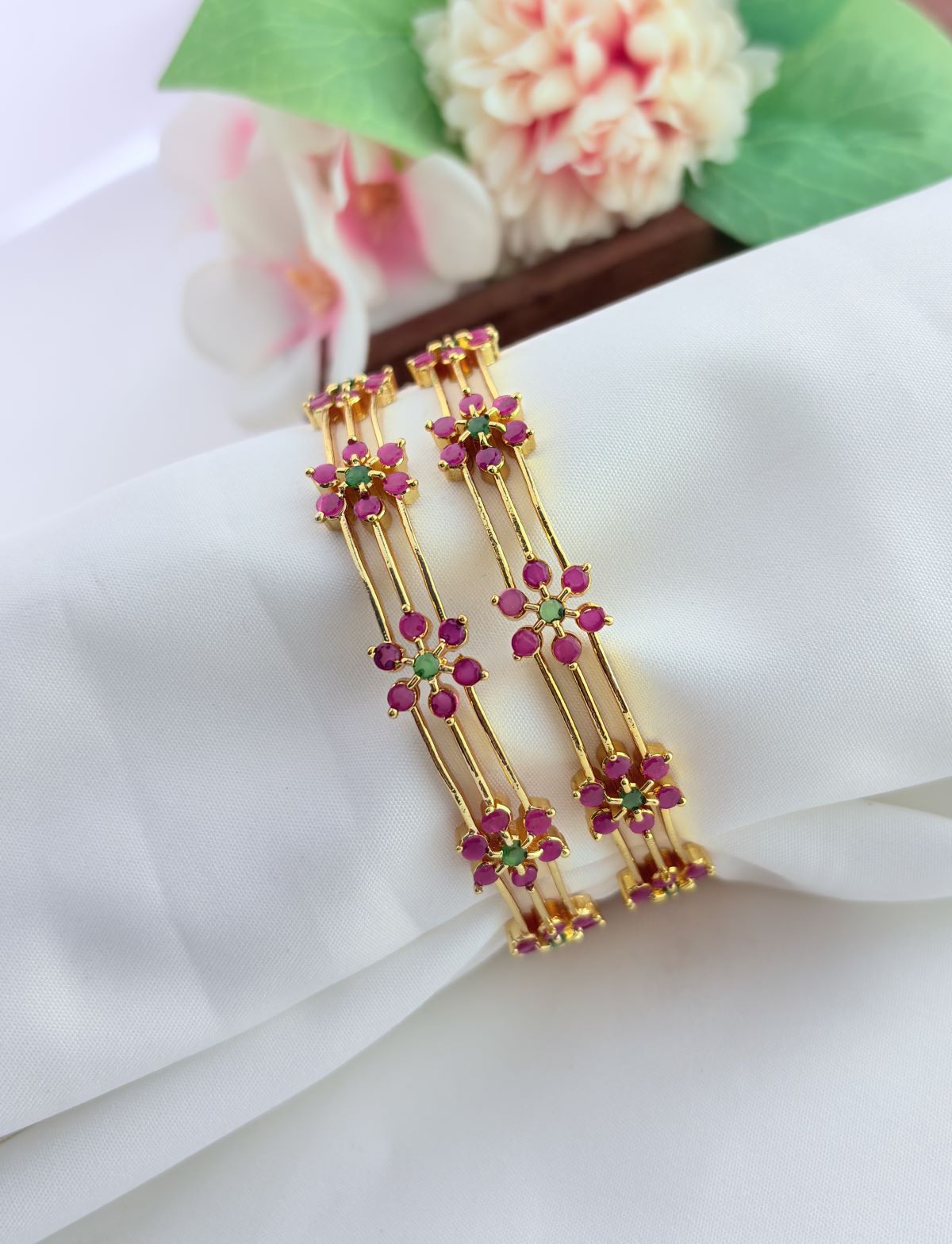 Elegant floral pattern bangles embellished with sparkling AD stones