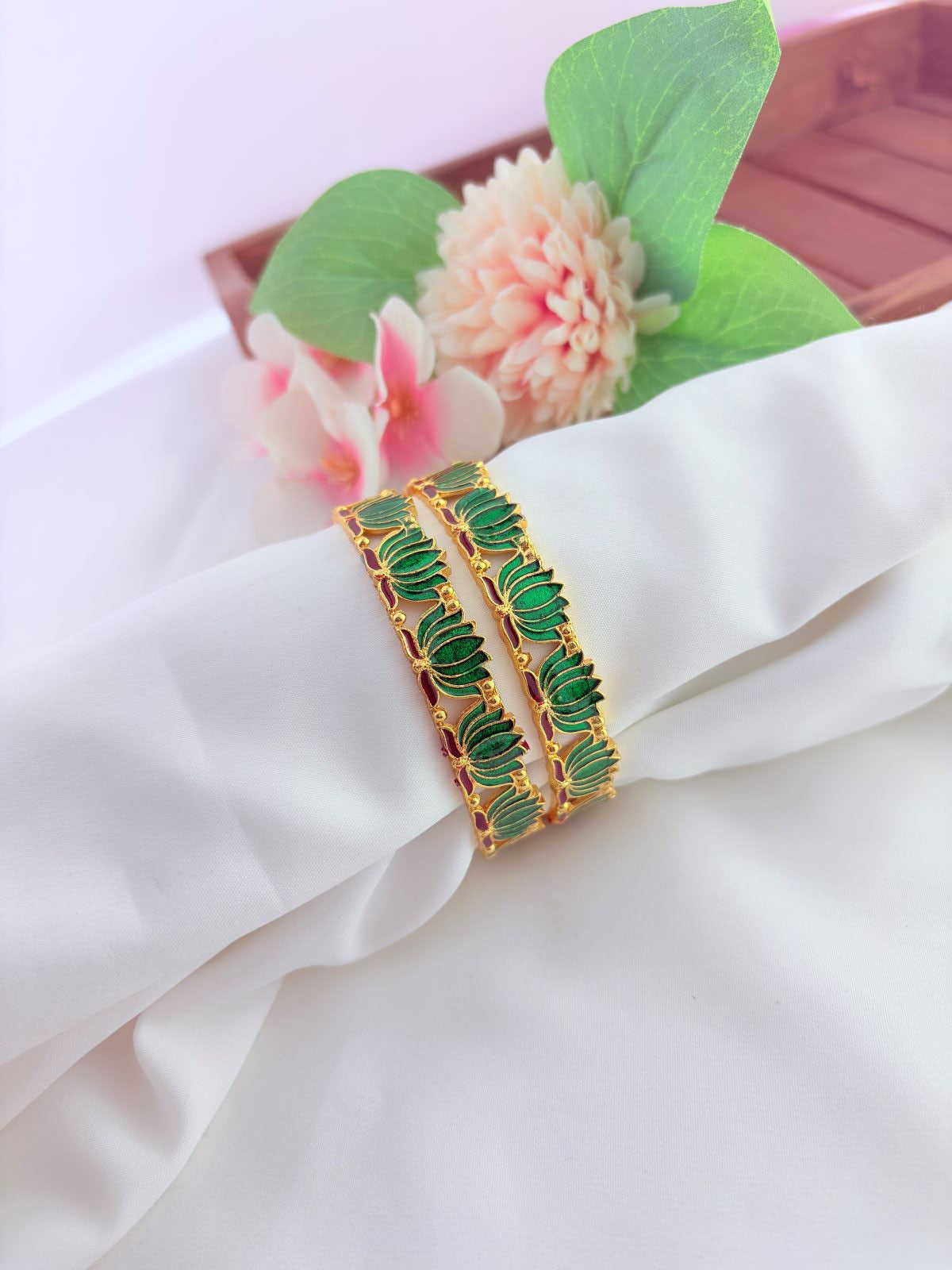 - Elegant lotus-inspired bangles crafted with fine detailing,symbolizing beauty and tradition