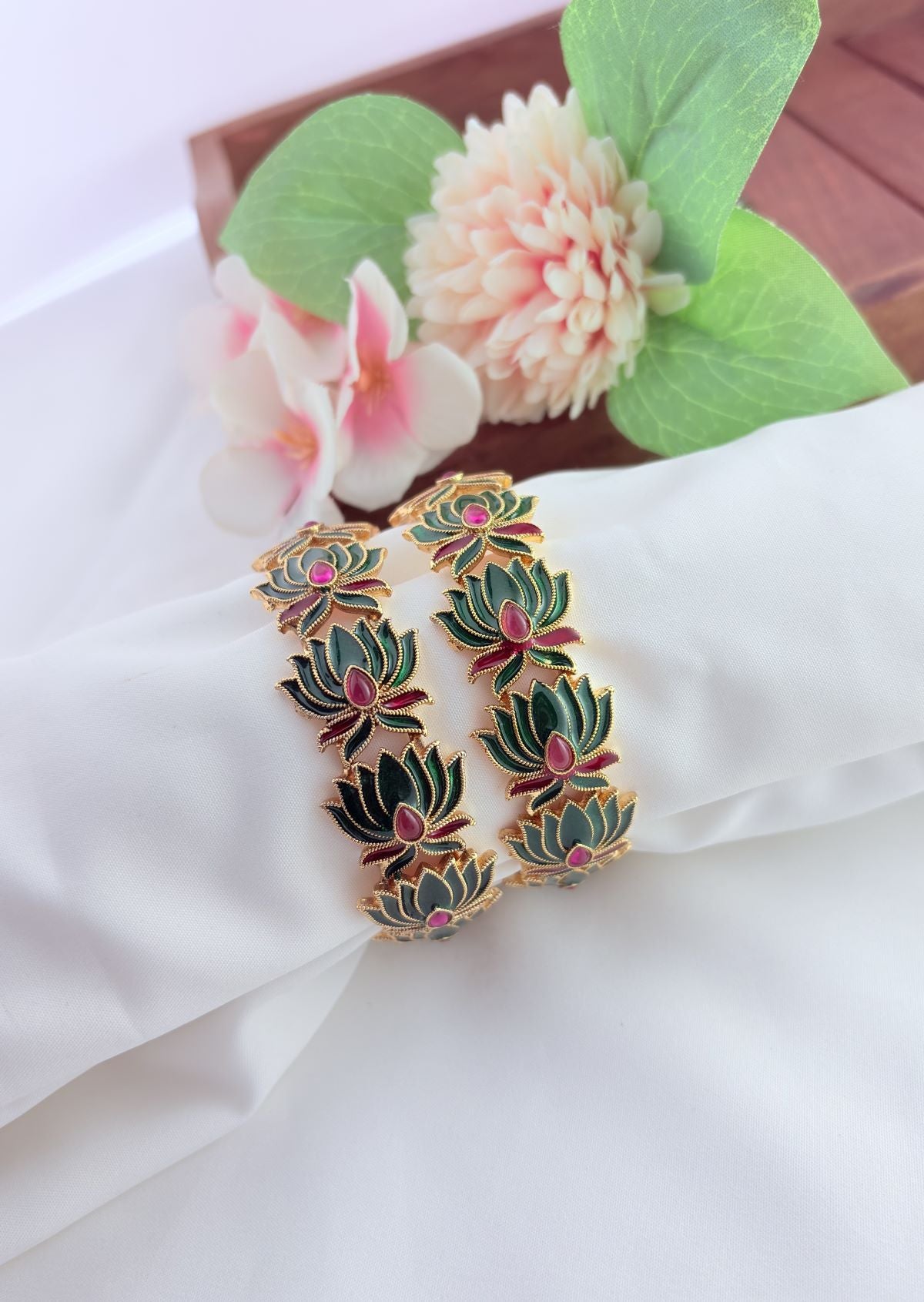 - Elegant lotus-inspired bangles crafted with fine detailing,symbolizing beauty and tradition