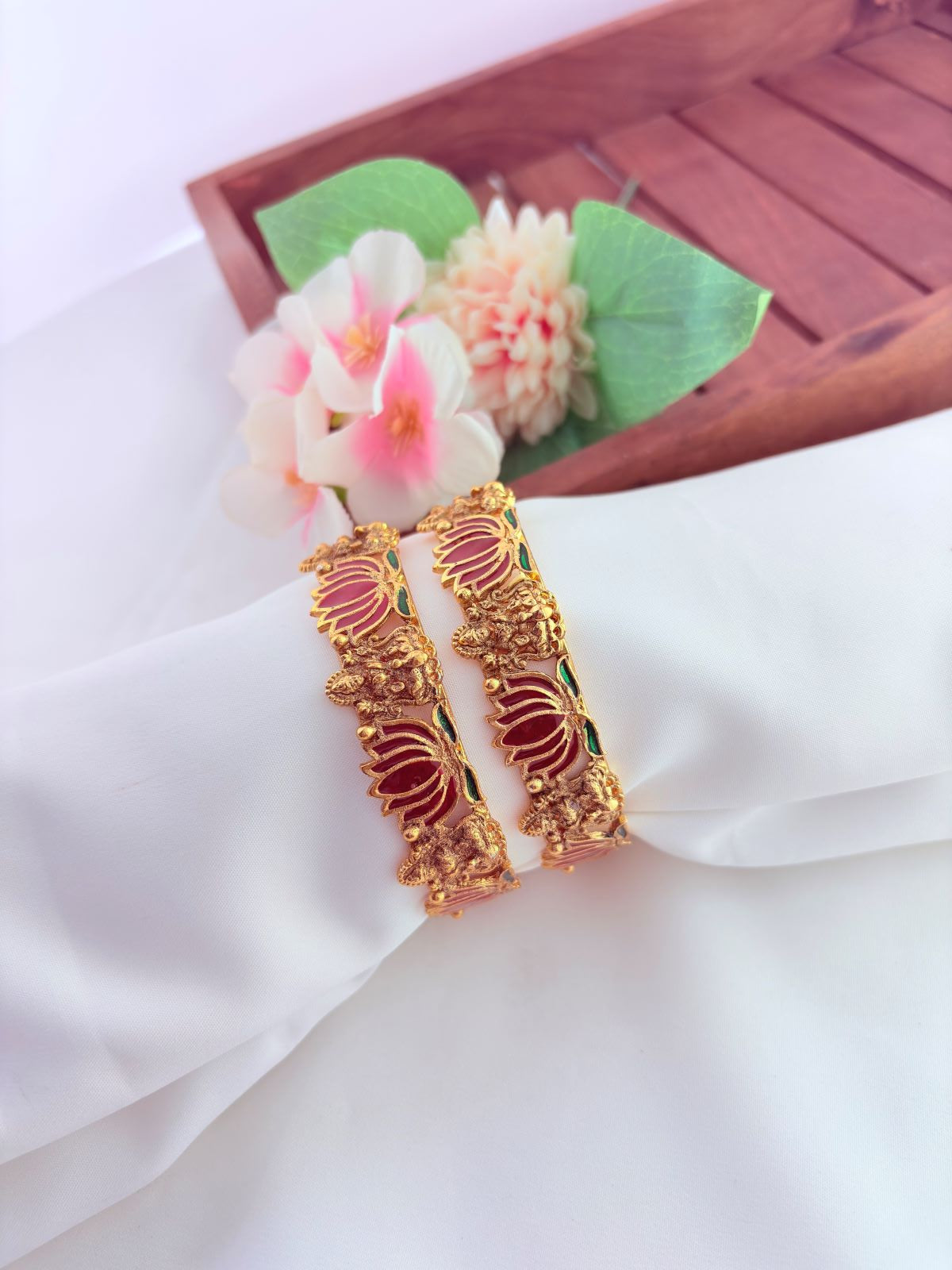 - Elegant lotus-inspired bangles crafted with fine detailing,symbolizing beauty and tradition