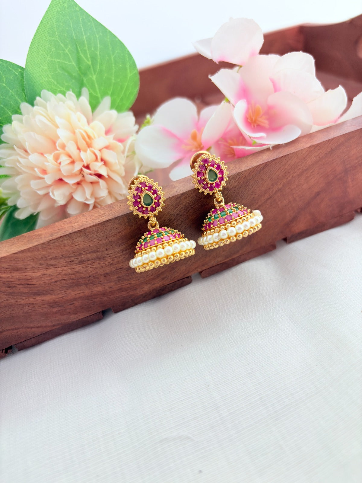 Premium matte finish jhumka beautifully crafted with classic AD stones and pearls