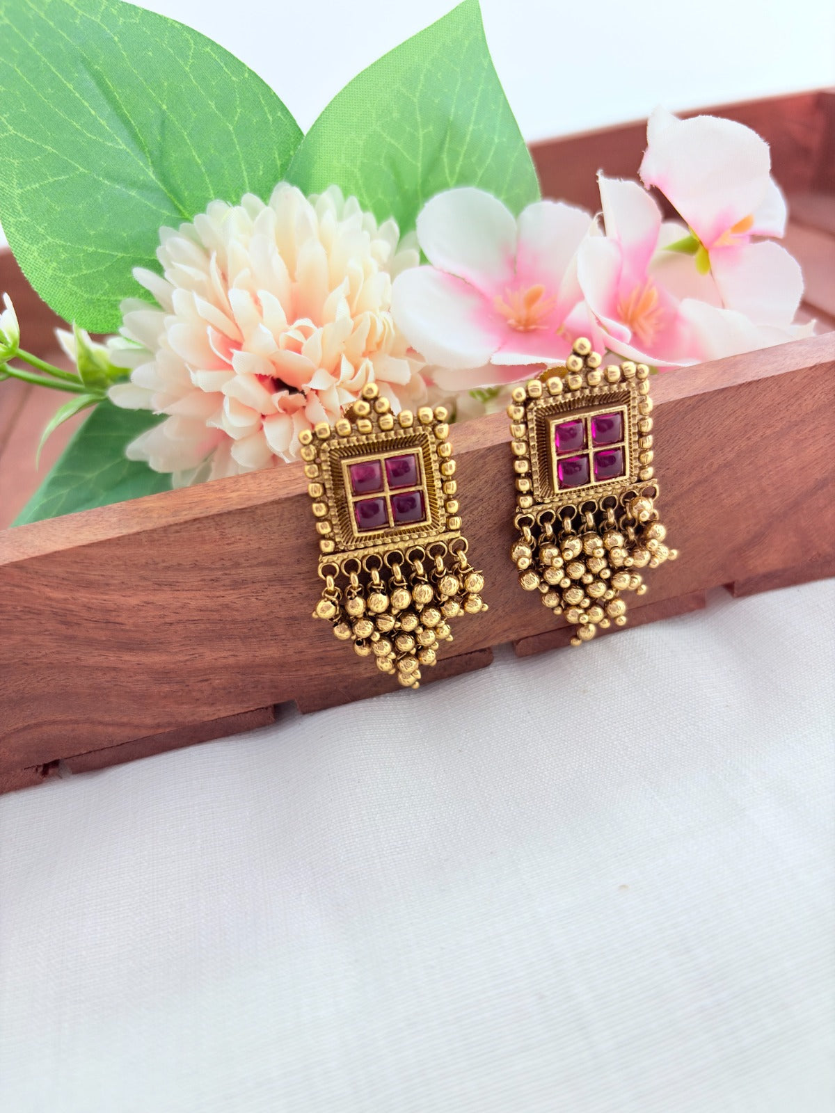 Premium matte finish traditional pattern earrings with golden beads