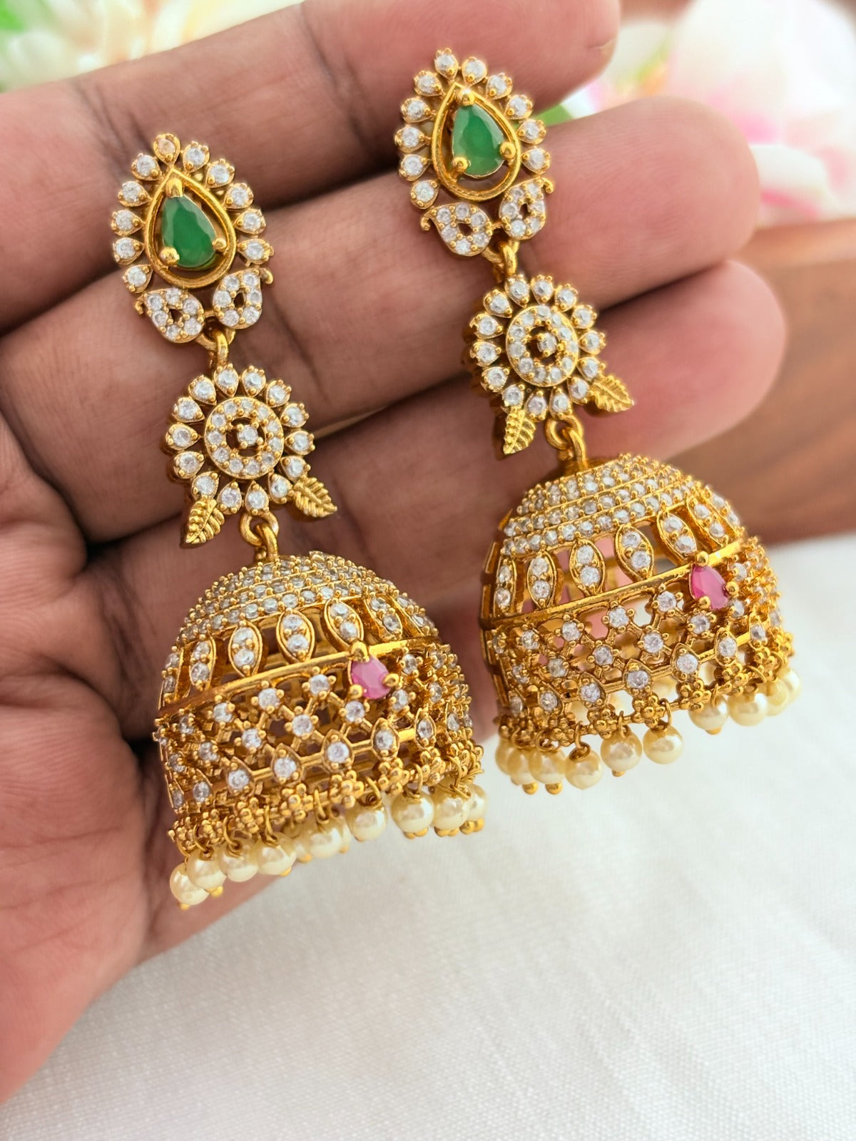 Premium matte finish jhumka adorned with AD stones and pearl drops