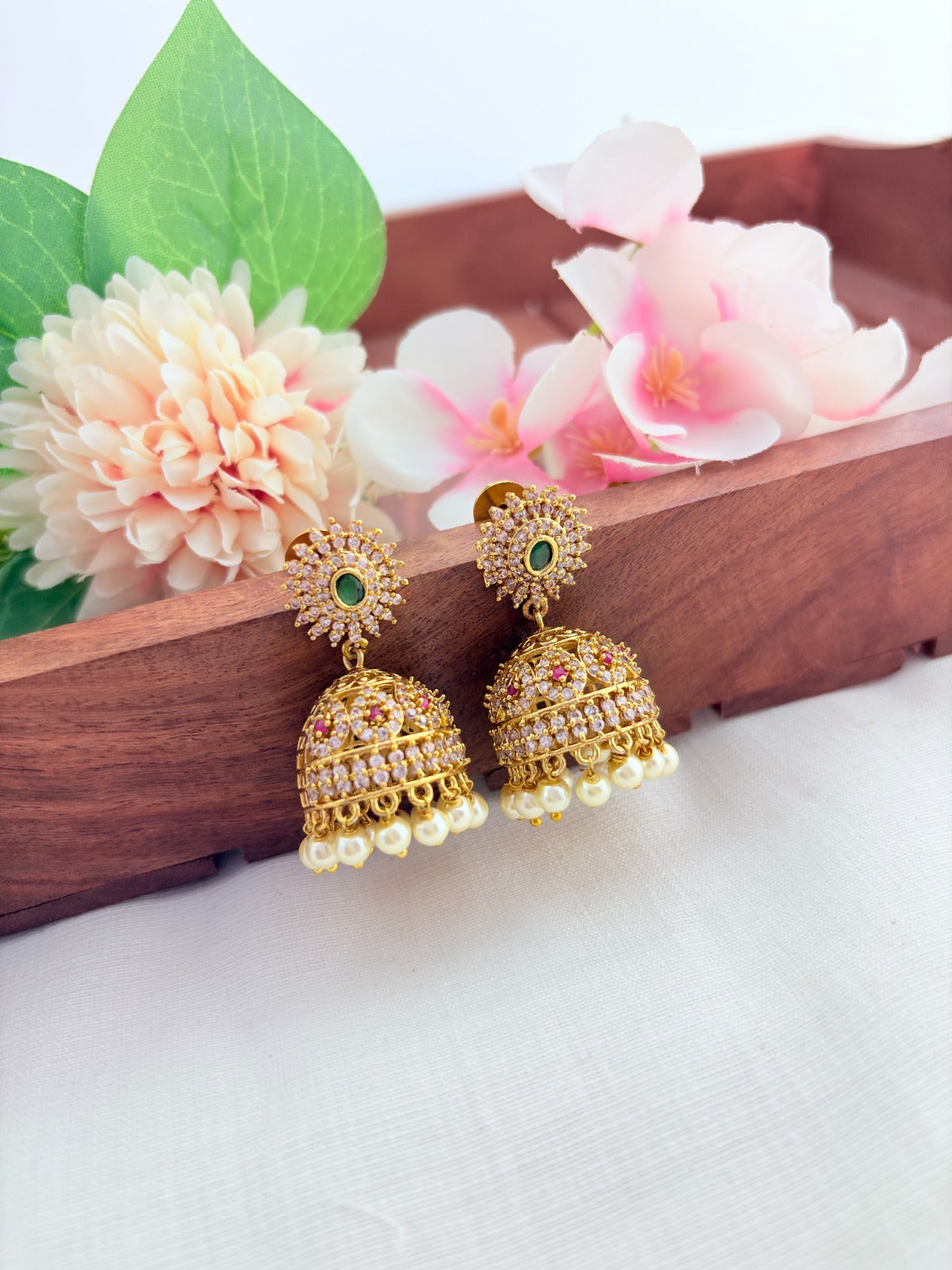 Premium matte finish AD jhumka beautifully adorned with pearl drops