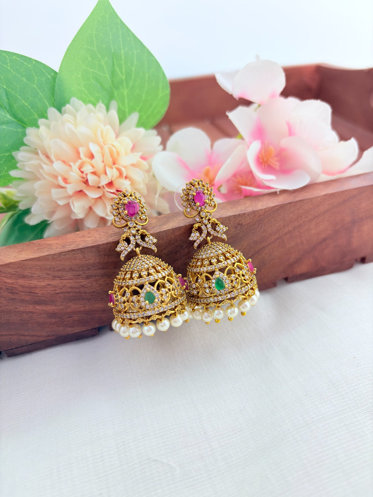 Traditional with modern appeal - Premium matte finish jhumka adorned with AD stones and pearl drops