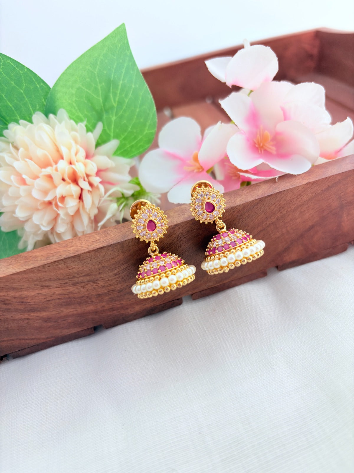 Premium matte finish jhumka beautifully crafted with classic AD stones and pearls
