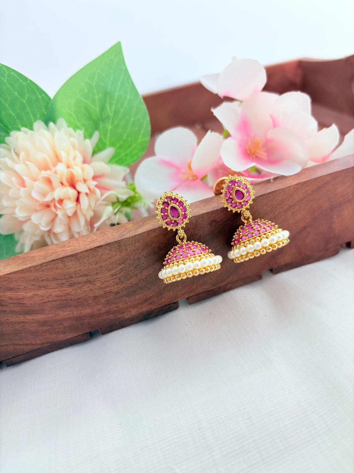 Premium matte finish jhumka beautifully crafted with classic AD stones and pearls