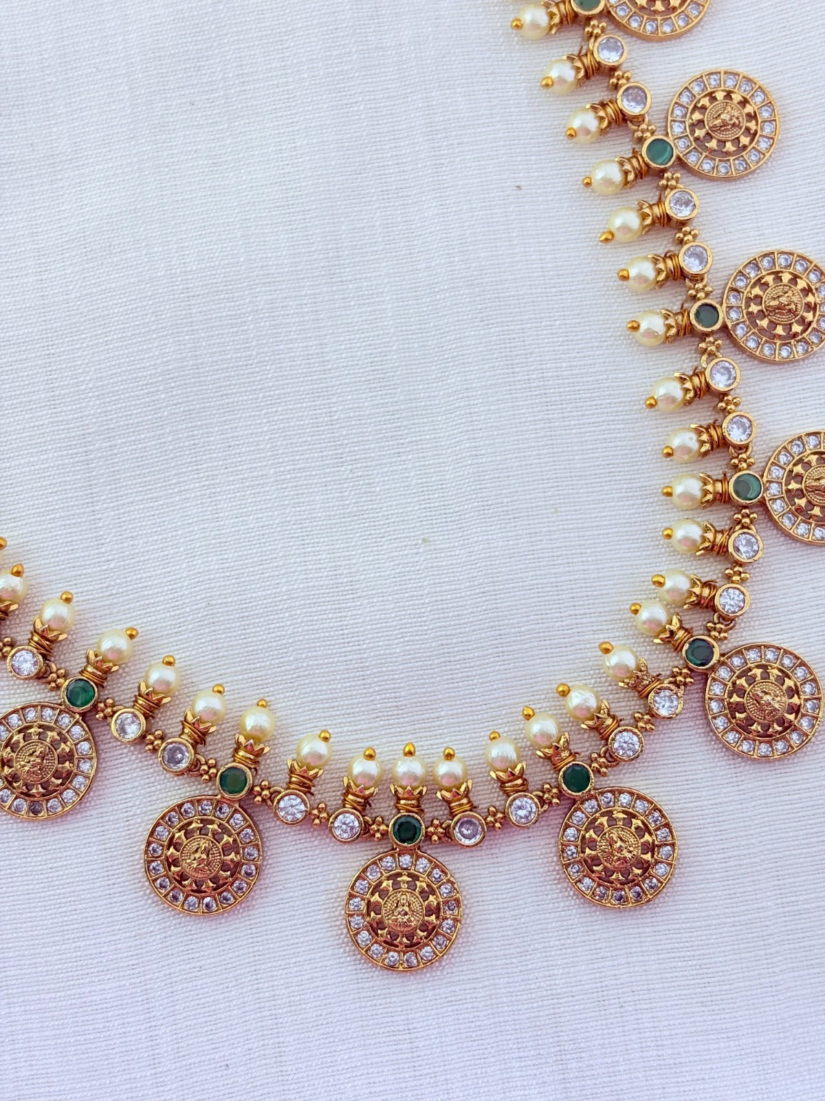 Traditional Lakshmi coin beautifully crafted with premium AD stones and pearl detailing