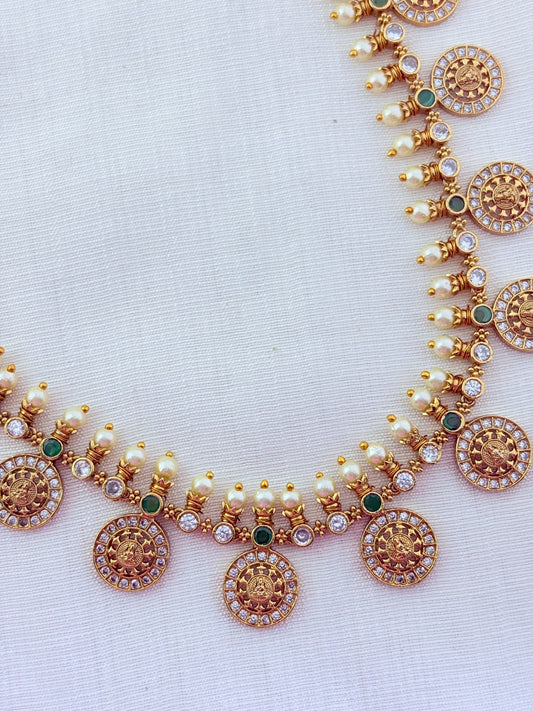 Traditional Lakshmi coin beautifully crafted with premium AD stones and pearl detailing