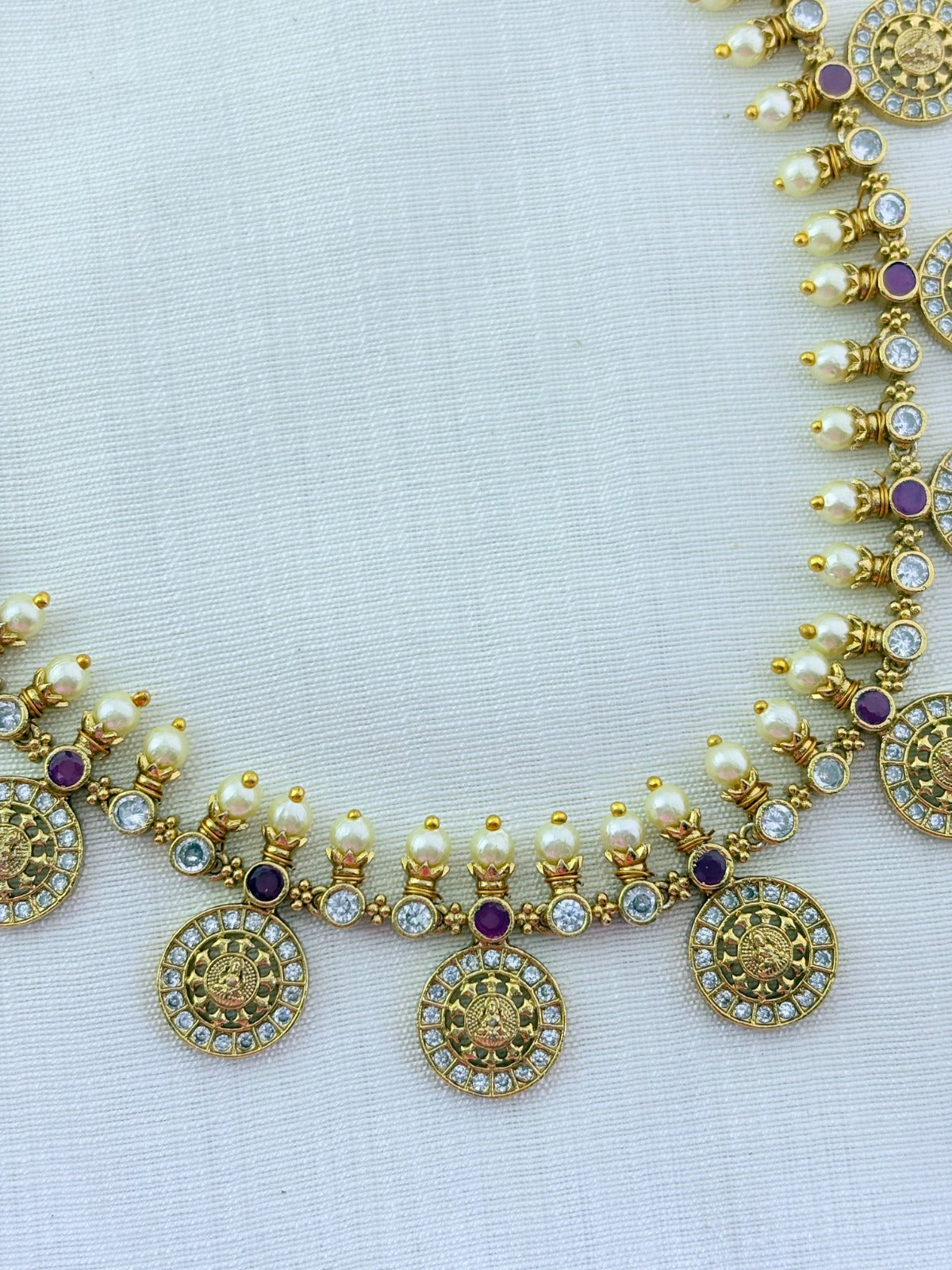 Traditional Lakshmi coin beautifully crafted with premium AD stones and pearl detailing