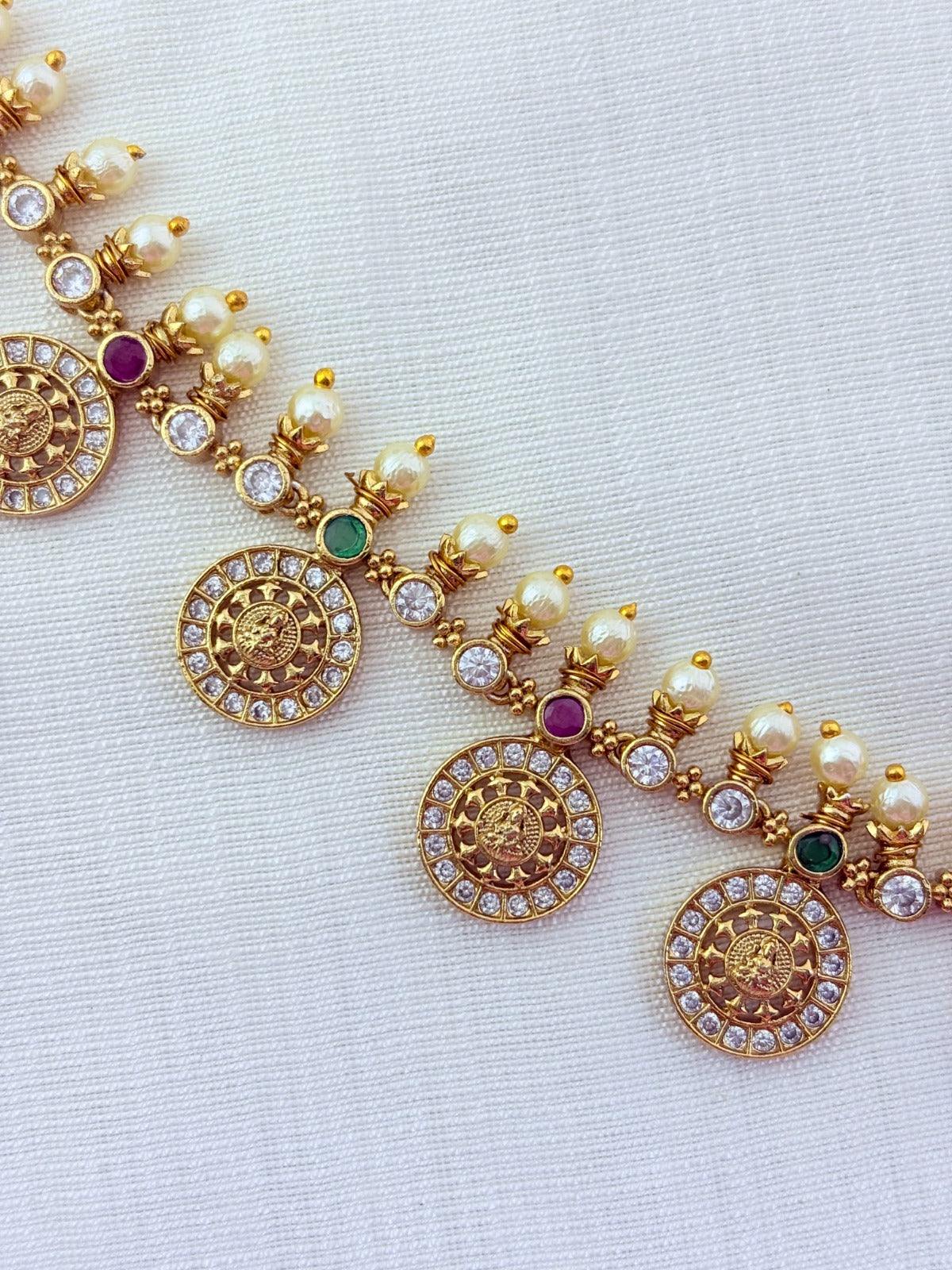 Traditional Lakshmi coin beautifully crafted with premium AD stones and pearl detailing