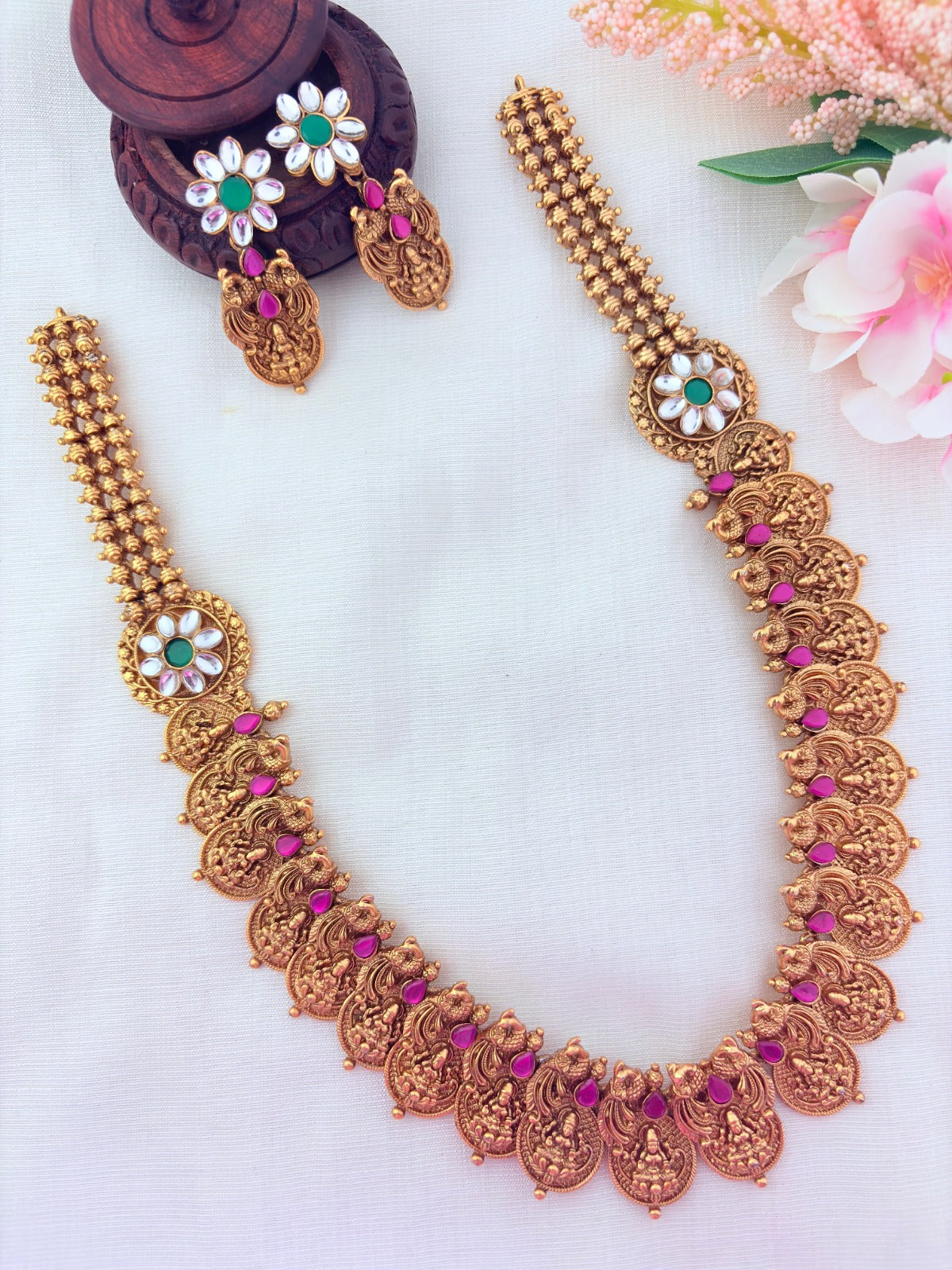 Matte finish peacock bridal haram and earrings adorned with classic stones