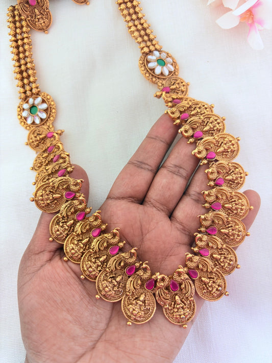 Matte finish peacock bridal haram and earrings adorned with classic stones