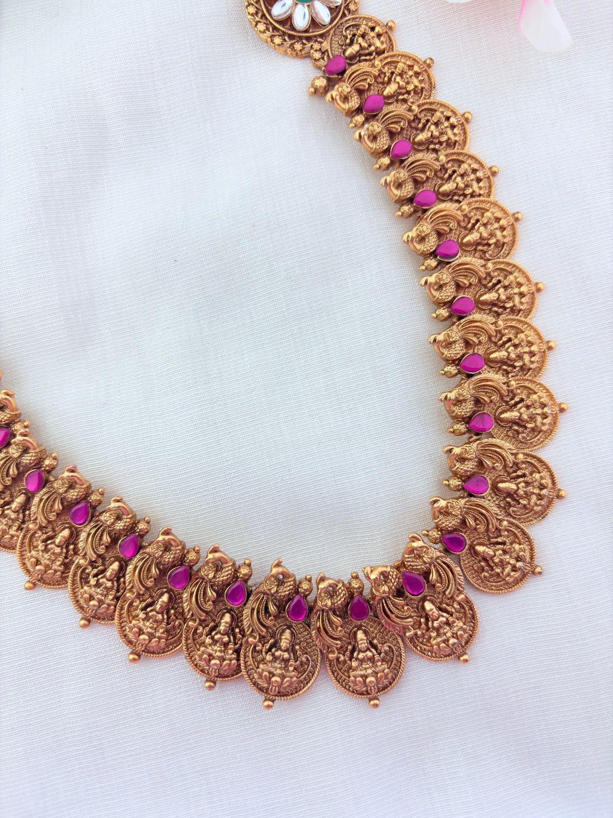 Matte finish peacock bridal haram and earrings adorned with classic stones