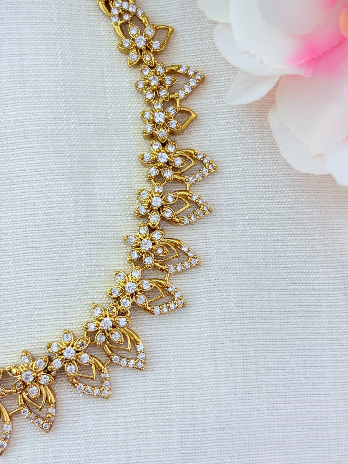 Elegant floral and leaf pattern premium AD matte finish haram with matching earrings