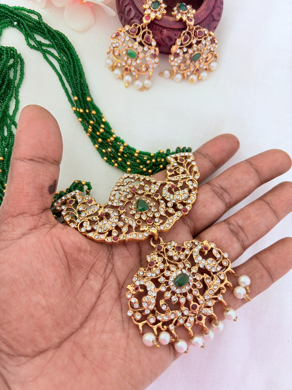 Stylish   beads haram featuring a statement pendant and matching earrings adorned with pearl drops