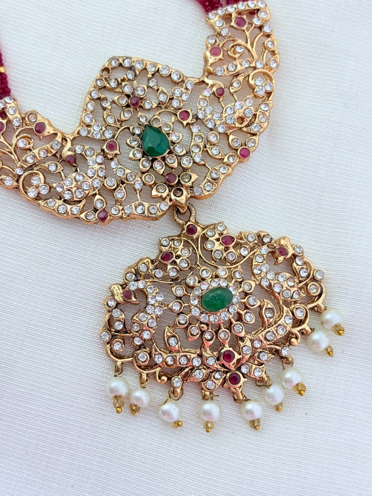 Stylish   beads haram featuring a statement pendant and matching earrings adorned with pearl drops