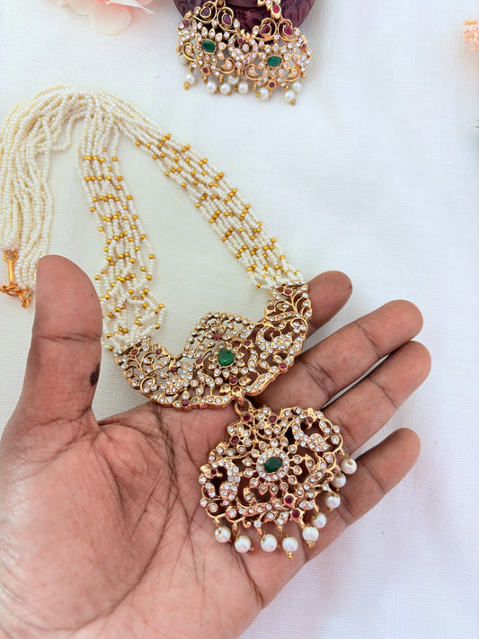 Stylish   beads haram featuring a statement pendant and matching earrings adorned with pearl drops