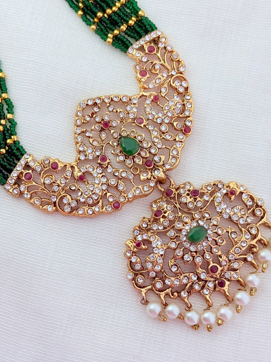 Stylish   beads haram featuring a statement pendant and matching earrings adorned with pearl drops