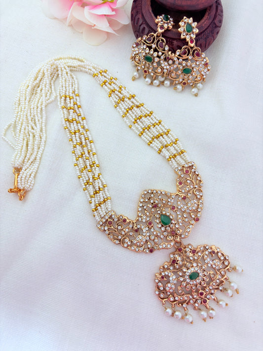 Stylish   beads haram featuring a statement pendant and matching earrings adorned with pearl drops
