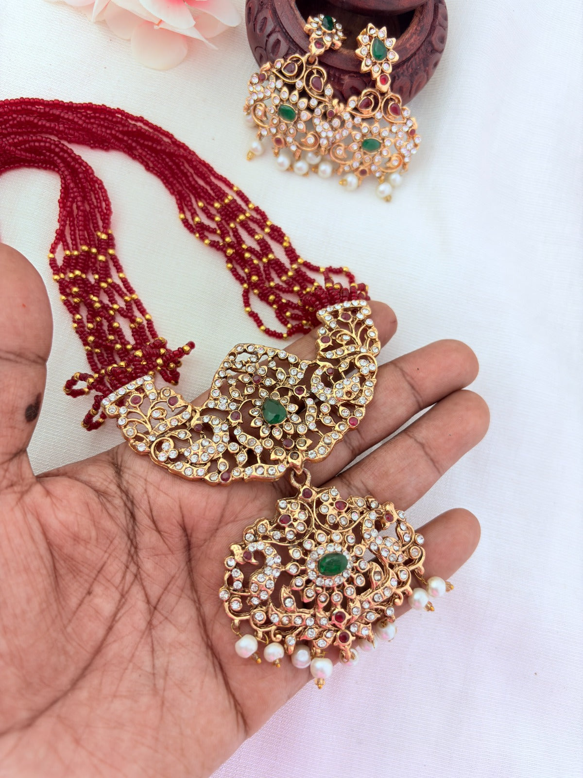 Stylish   beads haram featuring a statement pendant and matching earrings adorned with pearl drops